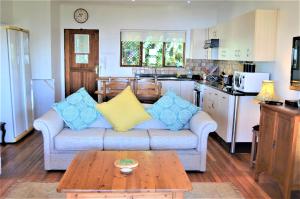 a living room with a couch and a coffee table at Gateside Guesthouse in Hilton