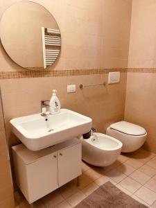 a bathroom with a sink and a toilet and a mirror at Berga Exclusive Suite 5 in Bari