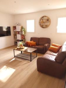 a living room with a couch and a coffee table at T3 avec jacuzzi privé exterieur in Ceyreste