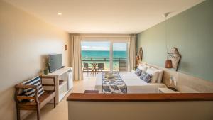 a bedroom with a bed and a view of the ocean at Pousada Dona Moça in Morro de São Paulo