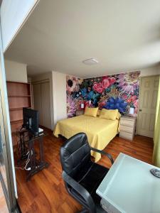 a bedroom with a bed and a desk with a chair at Playa Brava - Iquique in Iquique