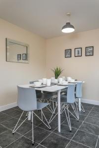 a dining room with a white table and chairs at The Durham House in Leyland