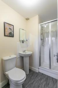 a bathroom with a toilet and a sink and a shower at The Durham House in Leyland