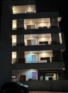 a tall building with a car parked in front of it at Passaddhi Serviced Apartment F2 in Mysore