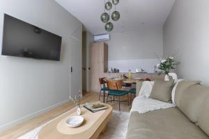 a living room with a couch and a table at MyKeypers - Luxury Apartment 4P - Le Marais / Bastille in Paris