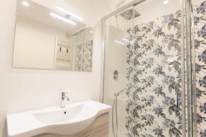 a bathroom with a sink and a shower at B&B Torre Canina suite & rooms in Trani +50 photos