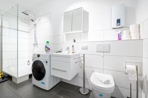 a white bathroom with a toilet and a sink at LiT LiVING - Luxus - Box SprIng - WH Old Town - Parking in Weinheim