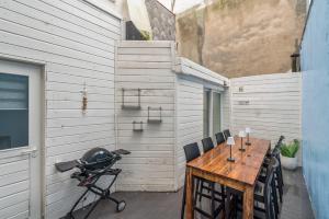 a small patio with a wooden table and chairs at Seaside 27 - De perfecte familie vakantiewoning aan zee voor 10p in Blankenberge