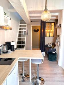 - une cuisine avec une table et des tabourets dans une pièce dans l'établissement Studio Cosy rue Sainte/St Victor, à Marseille