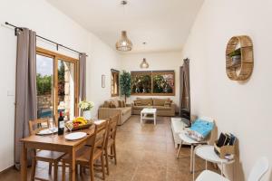 a living room with a table and chairs at Villa Windmill in Polis Chrysochous