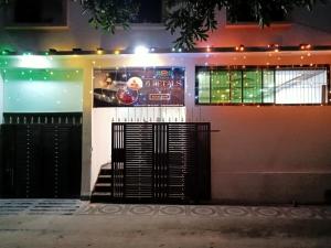 un bâtiment avec un panneau sur son côté la nuit dans l'établissement 5 PETALS, à Varanasi
