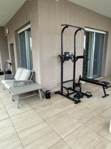 a living room with a bench and a gym at Lucia’s House in Bari