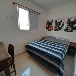 a bedroom with a bed and a window at Casa Nova Tatuapé in Sao Paulo