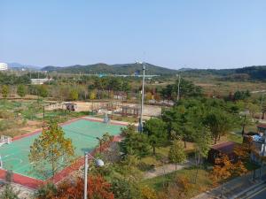 a playground with a tennis court in a park at 29 Play House in Incheon