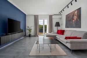 a living room with a couch and a tv at Luxury Villa Depollo in Donji Vinjani