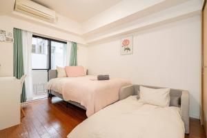 Llit o llits en una habitació de 新宿区歌舞伎町舒适露台房源徒步3分钟地铁站