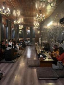 a group of people sitting on the floor in a room at Odin Hostel Shoja in Shoja