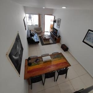a view of a living room with a table and chairs at Casa Nova Tatuapé in Sao Paulo