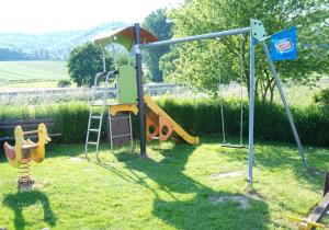 a playground with a slide and a swing at Gasthaus Zum Lindenwirt in Weißehütte