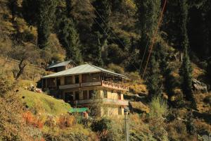 a house on the side of a hill at Odin Hostel Shoja in Shoja