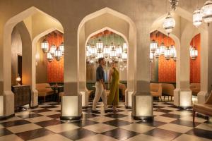 a man and woman walking through a lobby at Hyatt Zilara Cap Cana - Adults Only in Punta Cana +37 photos
