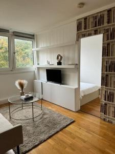 a white living room with a bed and a table at Apartment in Angel. in London