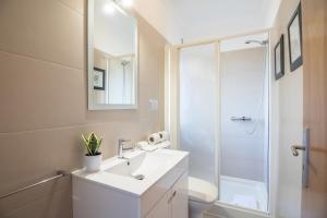 a bathroom with a white sink and a shower at Casa Clara in Vilamoura +27 photos