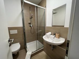 a bathroom with a shower and a sink and a toilet at LUX Apartments in Mörfelden-Walldorf
