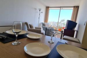 a table with glasses and plates on top of it at Departamento Vista hermosa in Santiago