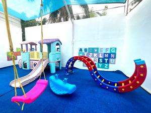 a childrens play area with a slide and swings at Issa's Haven Resort in Look +13 photos