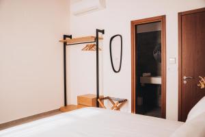 a bedroom with a bed and a mirror at MAZI - Pied à Terre in Rethymno Town