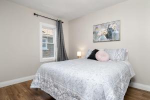 a bedroom with a bed with a pillow on it at Fields Inn Executive Townhouse in Kingston