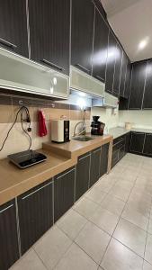 a kitchen with wooden cabinets and a counter top at Eehome in Ipoh