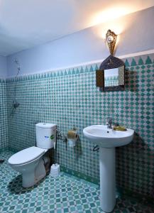 a bathroom with a toilet and a sink at Dar Aya Fes in Fez