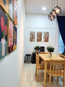 a dining room with a wooden table and chairs at Adinda Homestay @ RPB Hospital, Ipoh in Ipoh
