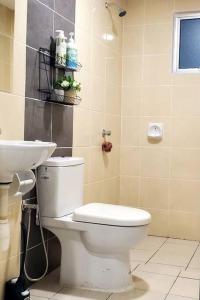 a bathroom with a white toilet and a sink at Adinda Homestay @ RPB Hospital, Ipoh in Ipoh +10 photos