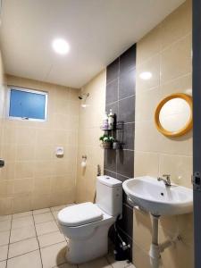 a bathroom with a toilet and a sink at Adinda Homestay @ RPB Hospital, Ipoh in Ipoh