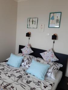 a bedroom with a bed with pillows on it at Apartman a város felett (Apartment above the city) in Eger