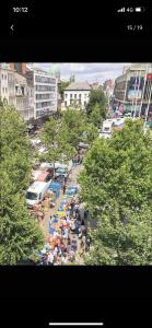 a crowd of people on a city street with trees at Charmante studio op toplocatie aan Meir. in Antwerp