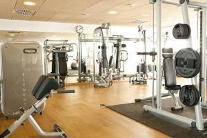 a gym with lots of exercise equipment in a room at Sunwing Alcudia Beach in Alcudia