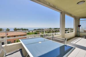 a glass table on a balcony with a view of the ocean at Apartment W 2 bathrooms at 400m from the beach in Nice