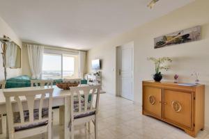 a kitchen and dining room with a table and chairs at Apartment W 2 bathrooms at 400m from the beach in Nice