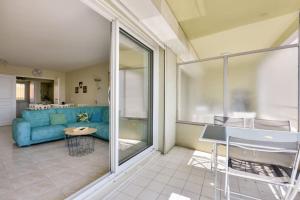 a living room with a blue couch and a table at Apartment W 2 bathrooms at 400m from the beach in Nice