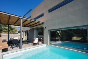a house with a swimming pool in front of a house at New Stylish Villa Domus Rodia with private pool & BBQ, 4km from Plakias beach in Marioú +46 photos