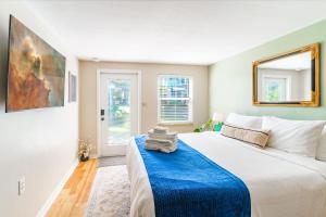 a bedroom with a large bed with a blue blanket at The Estate at Mt Dora in Mount Dora