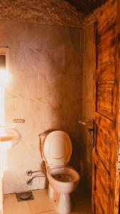 a bathroom with a toilet and a sink at Stamps Siwa Oasis in Siwa