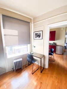 a living room with a table and chairs and a window at 2 Bedrooms Entire Beautiful Apt in Williamsburg! in Brooklyn