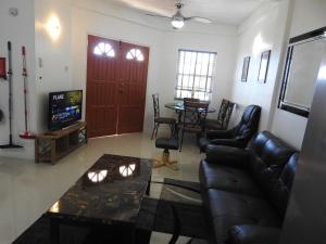 a living room with a couch and a tv at Belview Apartments in Belmont