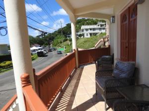 a porch with chairs and a view of a street at Belview Apartments in Belmont