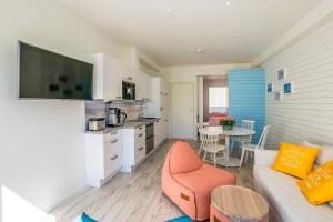 a kitchen and a living room with a couch and a table at Surf and Turf Apartment in Hanko in Hanko